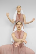 Two female dancers repeat the choreography