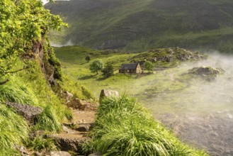 Hiking trail and mountain hut at the Lac des Gloriettes reservoir in the Pyrenees near