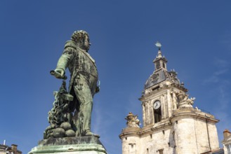 Admiral Duperré statue and the Porte de la Grosse Horloge clock tower in La Rochelle, France