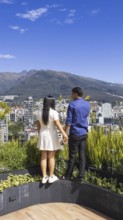 Quito, Ecuador, May 2 2025: Young tourist couple overview Carolina Park modern condominiums in