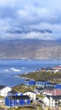 Panoramic view of Greenland capital Nuuk with colored houses located near fjords and icebergs