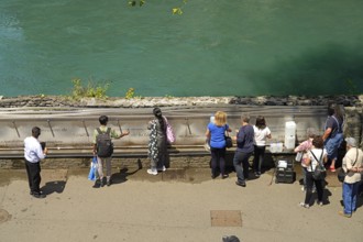 Pilgrims at the fountain with the holy water from the spring of the Marian pilgrimage site of
