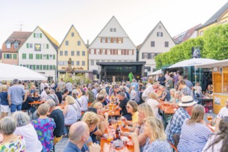 People gather on a market square to enjoy the summer evening, 950 years Weil der Stadt ceremony,