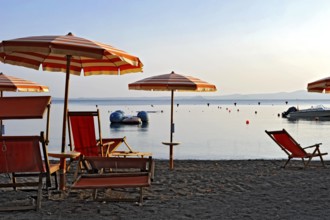 Beach, deckchairs, sunshades at the lido, Lake Bolsena, Lago di Bolsena, volcanic crater lake, calm