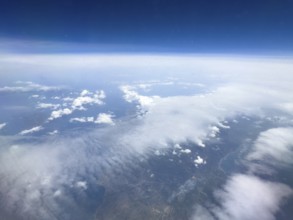 View from aeroplane at high altitude on white clouds Altostratus moving over coastal region of