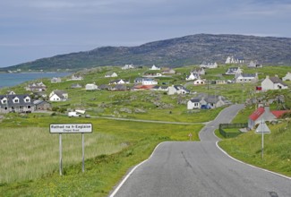 Small village in a hilly landscape with white houses and a main road, Outer Hebrides, Eriksay,