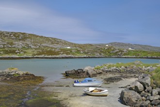Two boats on a rocky shore in a quiet bay under a clear sky in front of hills, Idyll, Outer