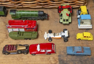 A selection of children's toy cars trucks train for sale on display at auction, UK