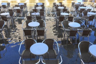 Piazzetta, chairs and tables of a restaurant in Acqua alta, Venice, Veneto, Italy
