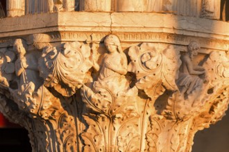 Figurative representation on a capital of the Doge's Palace, Venice, Veneto, Italy