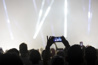 A visitor films the concert of Kylie Minogue live on Tension Tour 2025 in the Berlin Uber Arena on