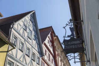 Advertising sign of the Zechmeister shoe market, behind it the half-timbered gables of the old