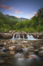 View of a waterfall of the Rio Plima stream in the evening light, long exposure, landscape photo,