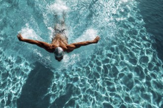 Muscular young swimmer swims in the lane. Concept of having purpose and determination and reaching
