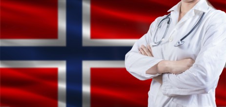 Doctor with crossed arms on Norway flag. Norway health and care concept. Female doctor on Norway