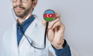 Doctor holding stethoscope with Azerbaijan flag. Azerbaijan health and care concept, Azerbaijan