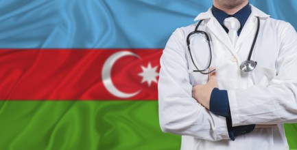 Male doctor with stethoscope on Azerbaijan flag. Doctor holding stethoscope on Azerbaijan flag