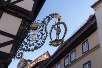 Traditional cantilever sign Zum Roland on a half-timbered house, Quedlinburg, Saxony-Anhalt,