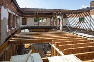 Detroit, Michigan - Workers rehab a long-vacant and crumbling commercial building in the