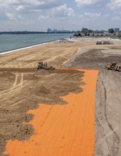 Detroit, Michigan - Workers spread clean dirt after old industrial contamination of cadmium,
