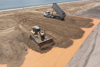 Detroit, Michigan - Workers spread clean dirt after old industrial contamination of cadmium,