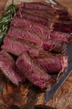 Fried steak, beef steak, rib eye steak, sliced steak, on a chopping board, top view, no people
