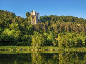 Prunn Castle on a steep cliff above the AltmÃ¼hl Valley in the evening light, reflection in the