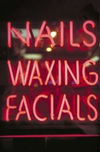 Illuminated advertising at a beauty parlour, Manhattan, New York City, USA