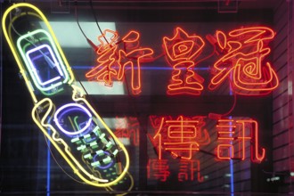 Illuminated advertising in a shop for cellphones, mobile phones, China Town, New York City, USA
