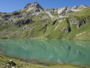 HIker at lake Engeratsgundsee, mountain range between Oberstdorf and Bad Hindelang, Allgaeu,
