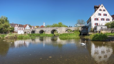 View over the river Wörnitz to the old town with the medieval stone bridge and the Herz Jesu