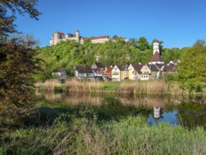 Castle and old town with St Barbara's Church reflected in the River Wörnitz, Harburg, Donau-Ries,