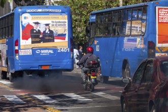 Buses in motion emitting pollution, City of Quito. Pichincha province, Ecuador, South America