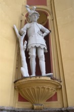 Sculpture of the giant Thyrsus, legendary figure, at the entrance portal of Wilten Abbey,