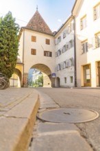 Historic old town centre with archway and cobbled street, peaceful and quiet atmosphere, Merano,