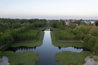 Symmetrically laid out avenues and a central water basin characterise the baroque palace garden in