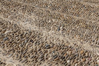 Street paving made of coloured pebbles, background, texture, Andalusia, Spain