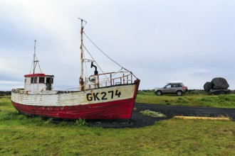 Shipwreck, fishing boat in a meadow, Gardur campsite near KeflavÃ­k, SuÃ°urnes, Sudurnes, Reykjanes