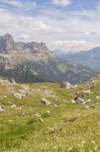 Green hills and mountains under a blue sky with soft clouds, hike to the Schlehrn, Alpe di Siusi,