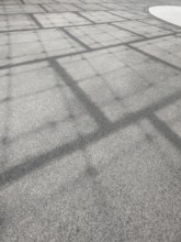 Roof construction casts shadows on the ground, Olympic Park, Munich, Bavaria, Germany