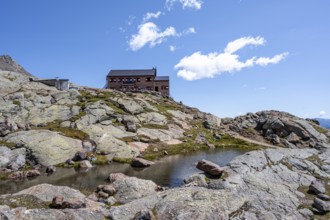 TeplitzerhÃ¼tte mountain hut and small mountain lake, Stubai Alps, South Tyrol, Italy