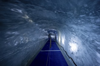 Artificial ice cave through the glacier ice, Mer de Glace, Montenvers, Chamonix, Haute-Savoie,