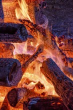 Logs of burning wood burning in a bonfire during a religious festival in honor of Saint John in