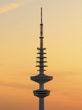 Television tower Heinrich-Hertz-Turm (Telemichel) in front of a yellow sky at sunset, Hamburg,
