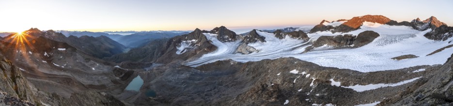 Panorama at sunrise with sun star, high mountain landscape, view of blue glacial lakes, mountain