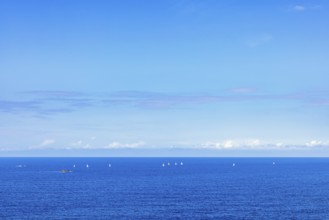 Sea view towards the horizon with sailboats sailing on the blue sea a sunny summer day, Crozon