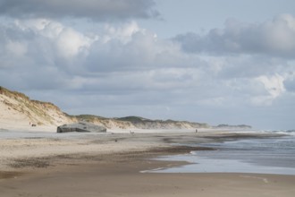 Wide beach with sand dunes and cloudy sky along the coast, near Hvide Sande, North Sea, Denmark