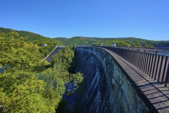 High view of a large dam with neighbouring forest and clear sky, summer, Urft dam wall, Obersee,
