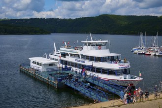 Passenger ship Stella Maris, at the landing stage, with tourists and neighbouring boats, summer,