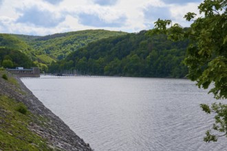 A lake with a wooded shore under a partly cloudy sky, summer, Rursee, Rurtalsperre, Heimbach,